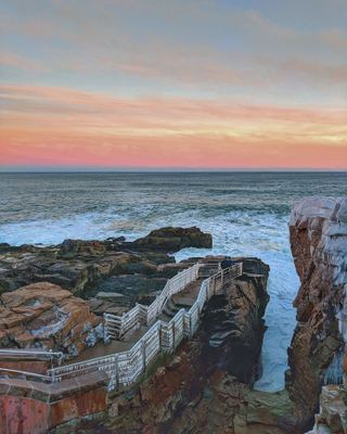 The wooden stairs down into Thunder Hole at dusk, Acadia National Park, Maine